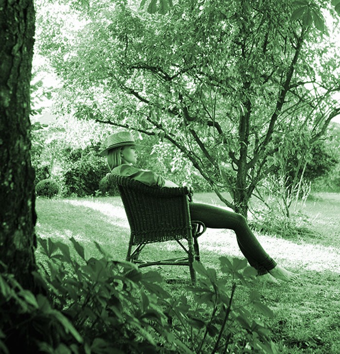 Mid adult woman asleep in garden chair